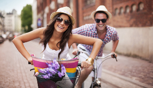 a woman with a man on a bicycle